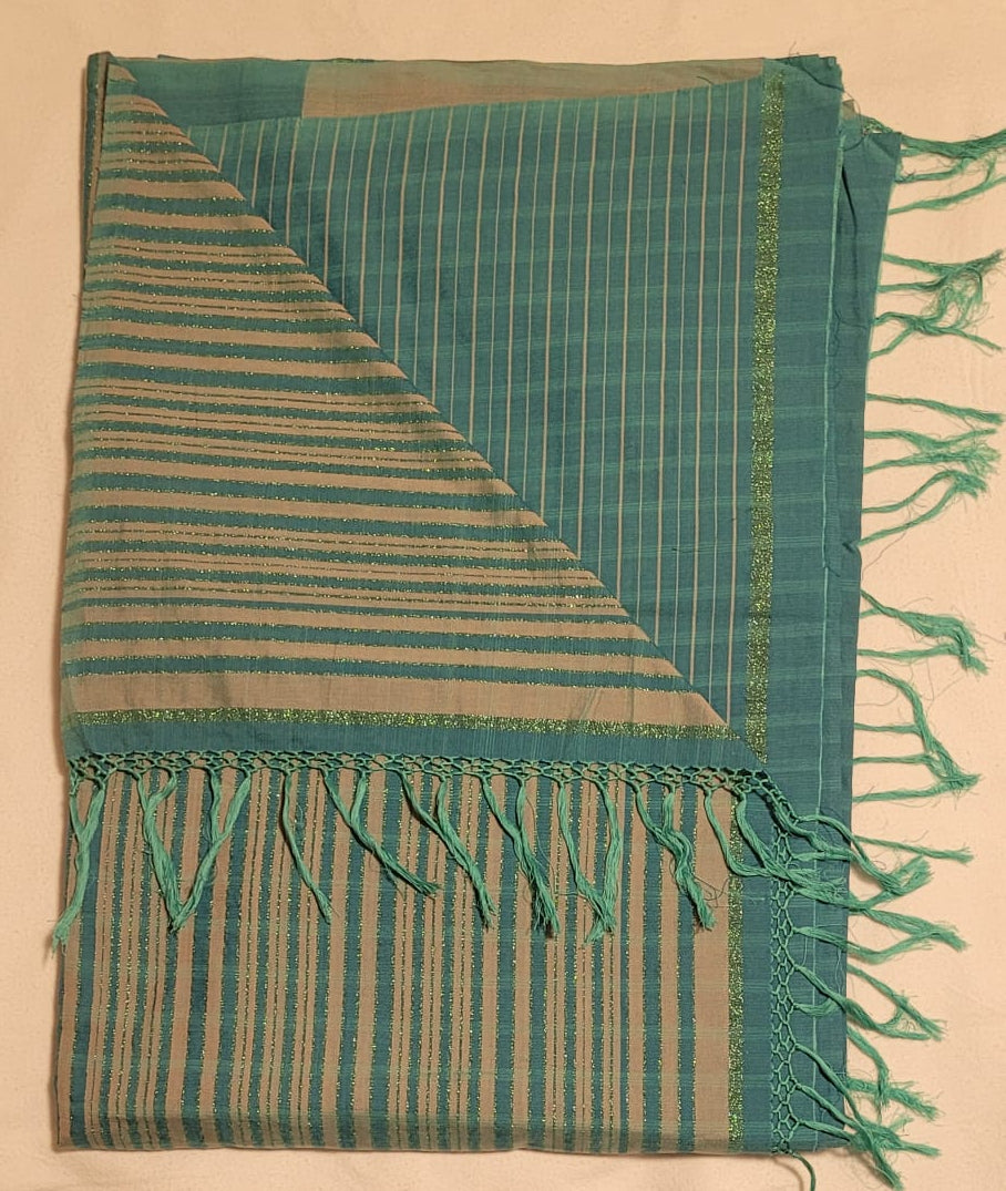 Teal woven saree with fringes on a beige surface